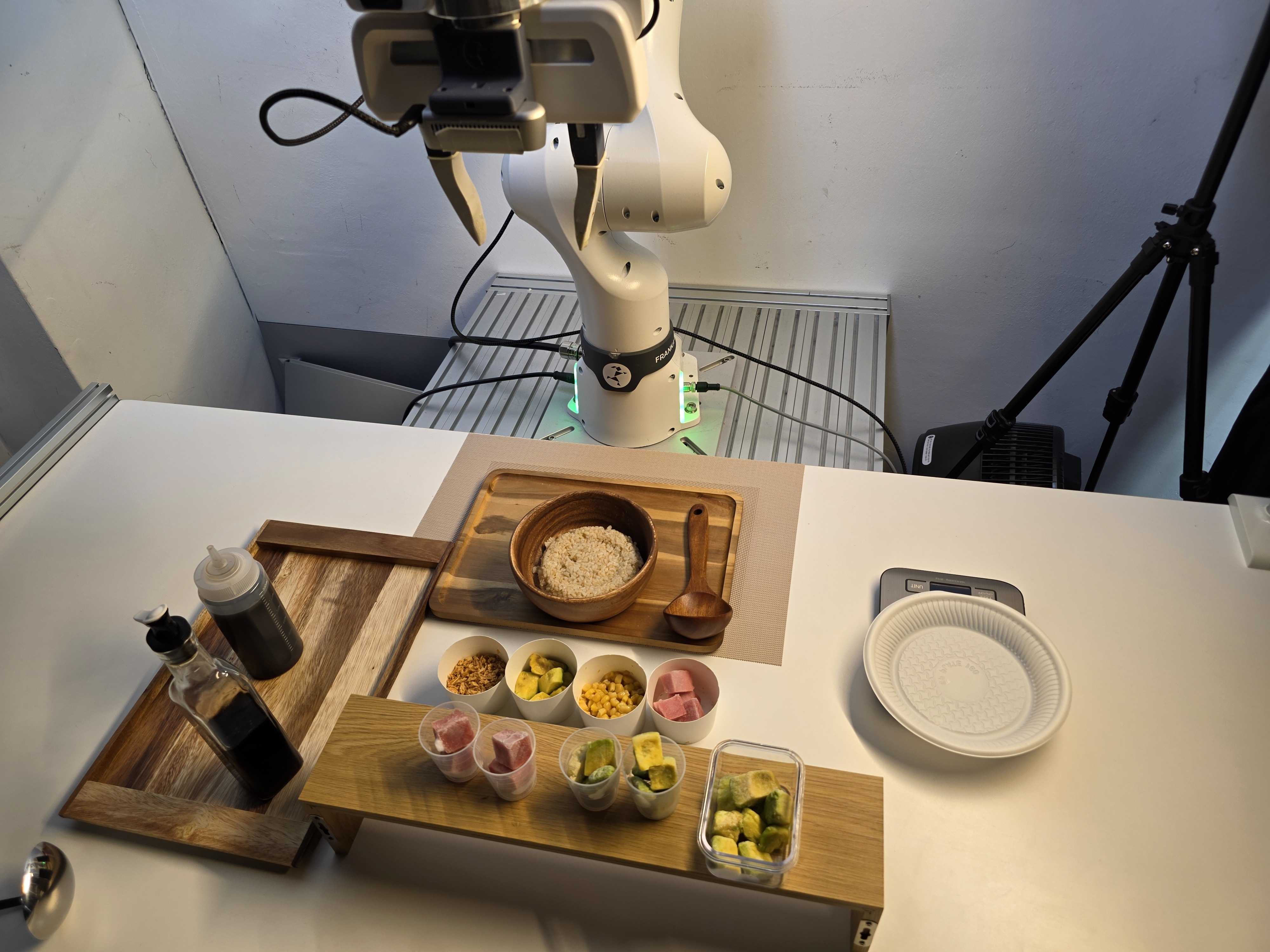 Franka robot and meal-preparation ingredients arranged on a workbench
